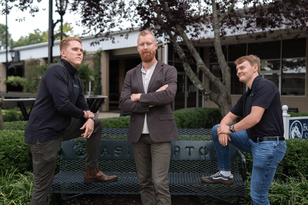 Director of Customer Success Clay Watson (left) and AVAIL developers Zach Jones and Tucker Overton play with team poses at AVAIL’s industry leadership event Confluence in Lexington, Kentucky September 2024.