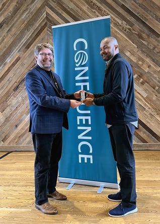 AVAIL’s Randall Stevens hands IMEG’s Michael Edwards the 2024 AVAIL Champion of the Year julep cup at Confluence Lexington 2024 for AEC technology leaders.